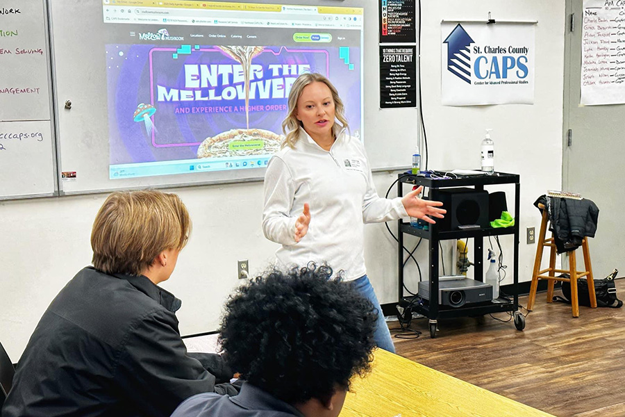 A woman is presenting to a room of CAPS students